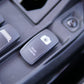 Dashboard rocker switch labeled rear camera with a camera icon