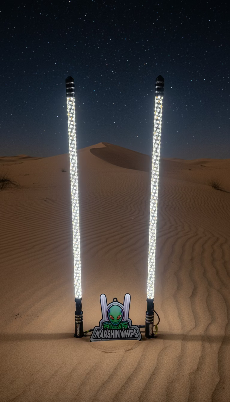 Two Marshin Whips with LED lights in the sand, featuring the Marshin Whips logo.