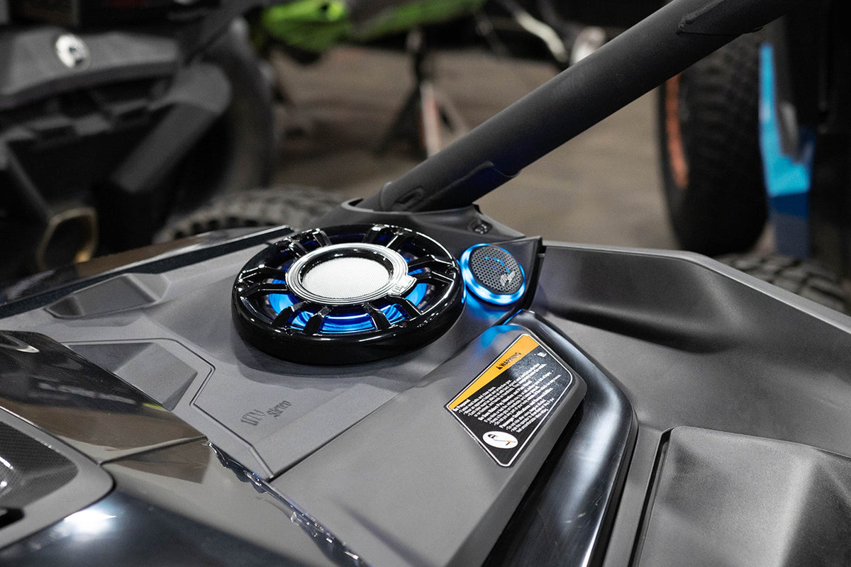 MTX Audio speaker system with blue LED lighting installed on a UTV dashboard