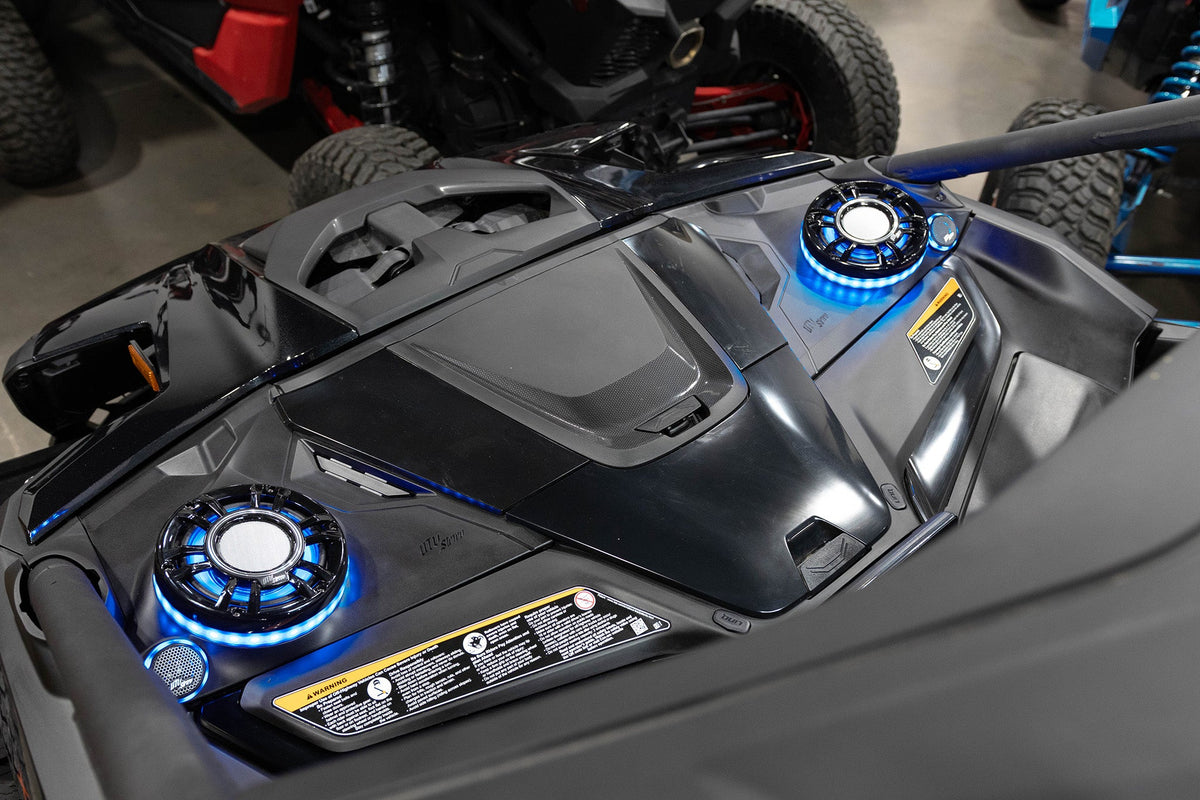 UTV Stereo speakers with blue LED rings installed in a vehicle dashboard