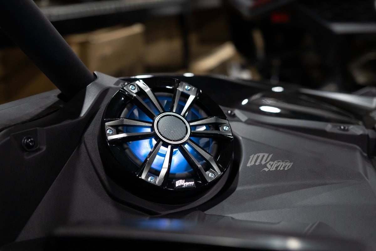 UTV Stereo speaker with blue LED lighting mounted in a vehicle dashboard