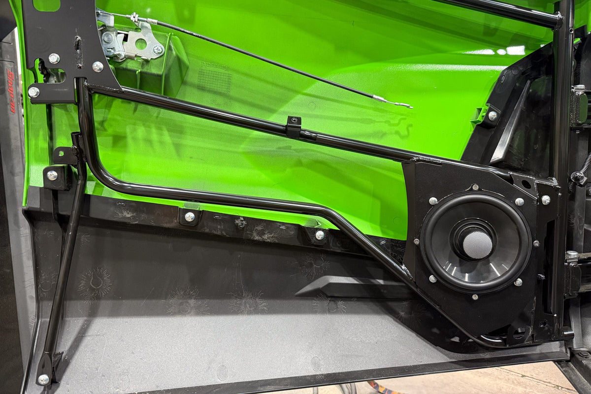 Kawasaki vehicle door interior with black metal frame and mounted speaker