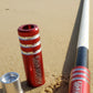 Single Red Game Changer Whip on a sandy beach with ocean waves in the background