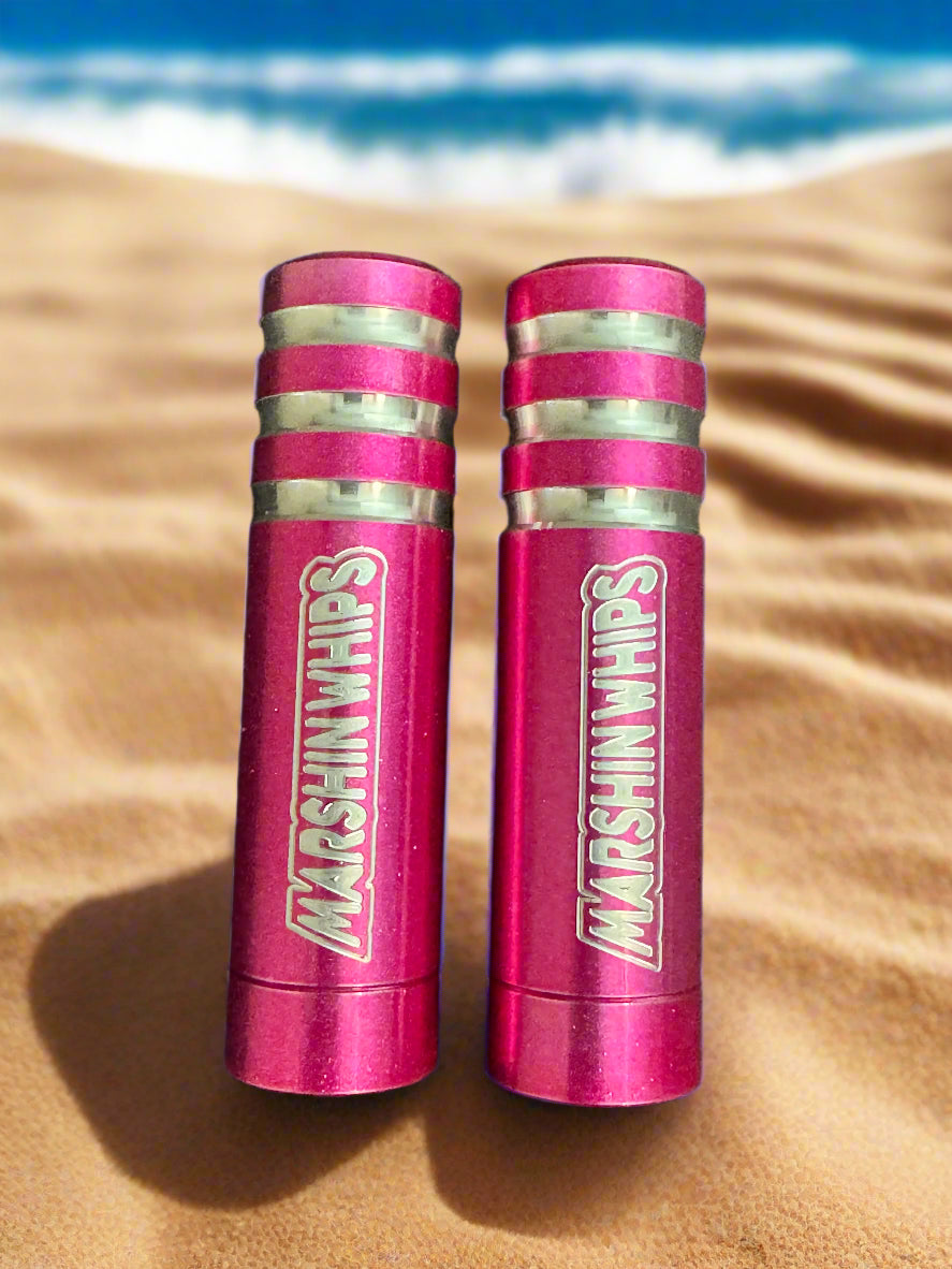 Two pink Marshin Whip bases on a beach