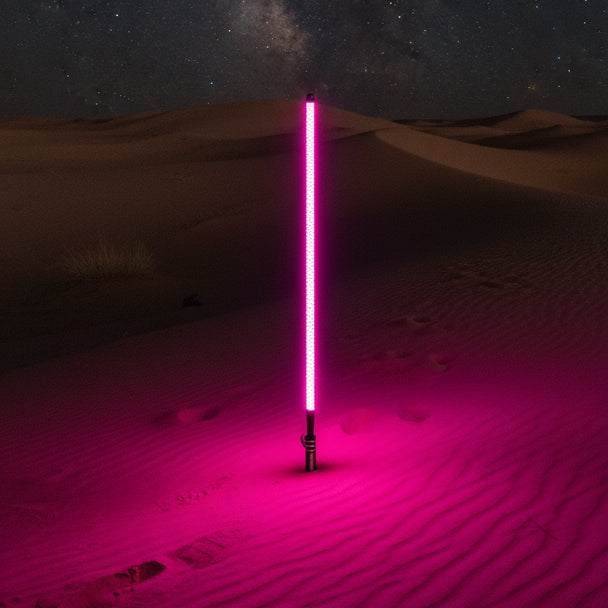 Pink LED baton with a logo on a sand dune background