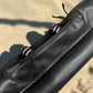 Black carbon fiber rod case on a textured surface