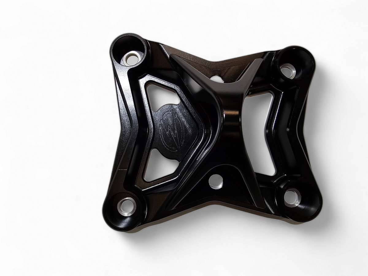 Black anodized 6-bolt radius rod plate installed on Can-Am Maverick X3 protecting rear suspension heim joints