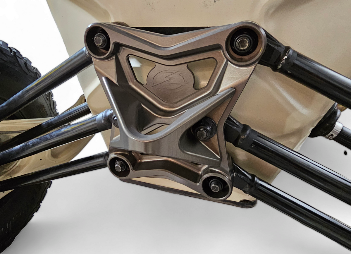 Gun metal radius rod plate installed on Can-Am Maverick X3 showing rear suspension fitment