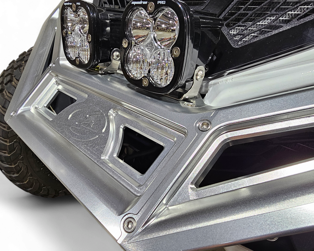 Full machine front view of Can-Am Maverick X3 fitted with clear anodized billet winch bumper and aggressive stance