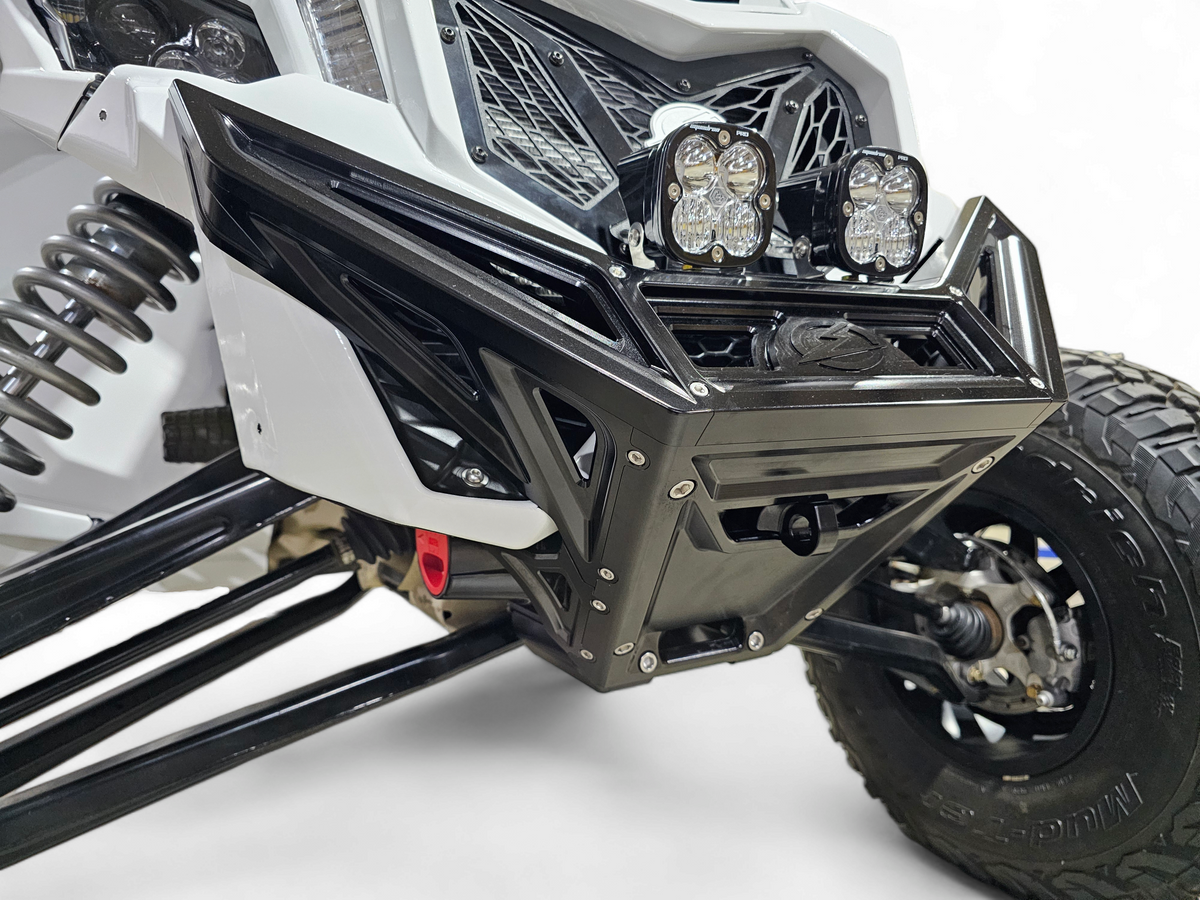 Full machine front view of Can-Am Maverick X3 fitted with black anodized billet winch bumper and aggressive blacked-out stance