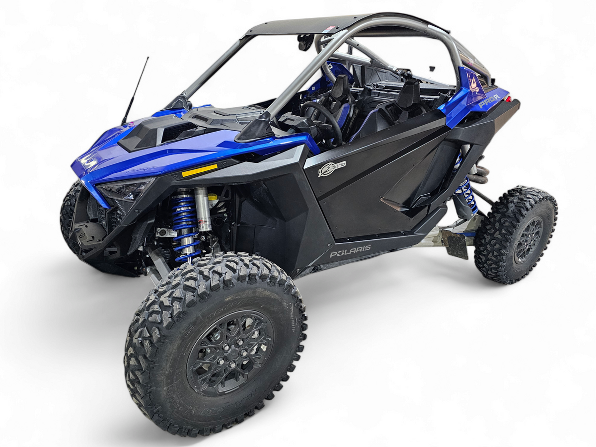Amp Door Skins installed on 2-seat Polaris RZR Pro R showing one-piece aluminum design in satin black