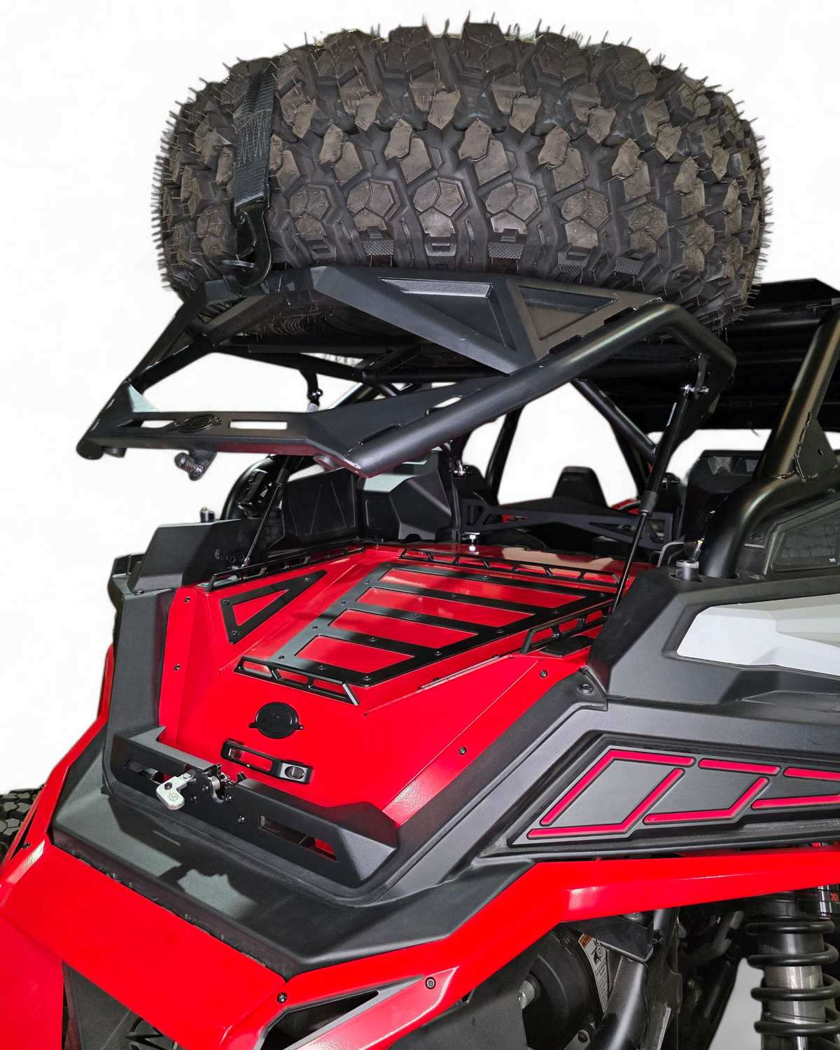 Polaris RZR high clearance tire carrier shown with a 35-inch spare tire mounted