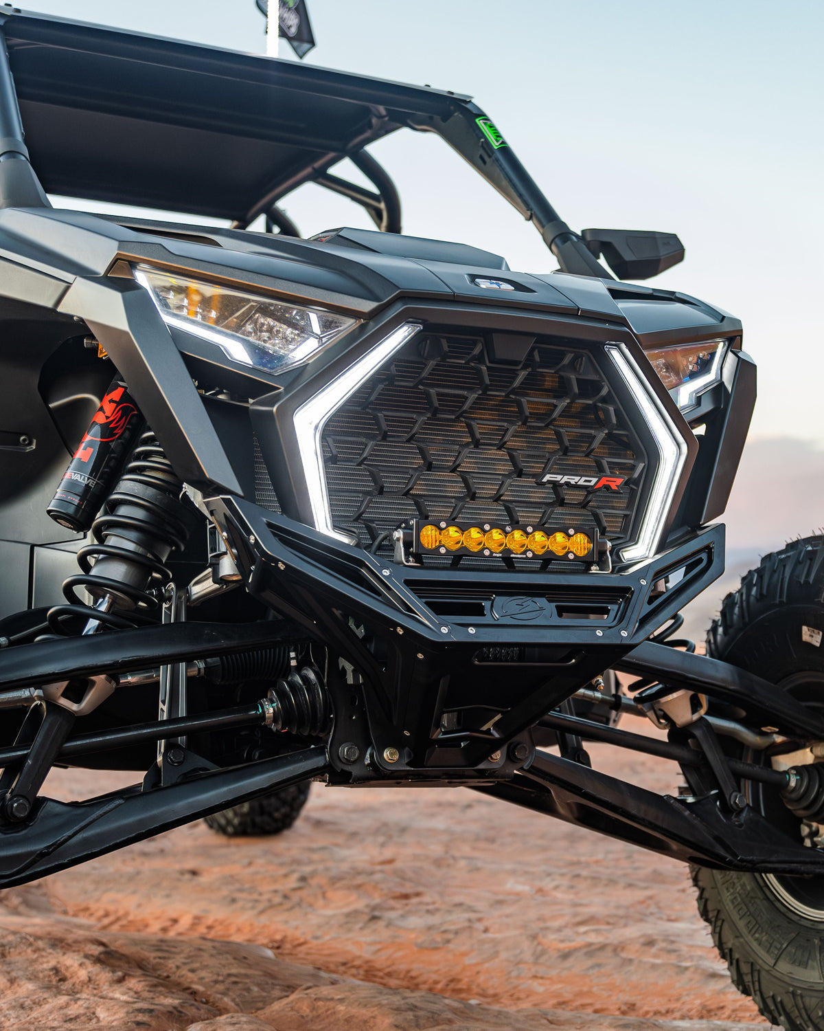 Front three-quarter view of Polaris RZR billet front winch bumper showing CNC machining