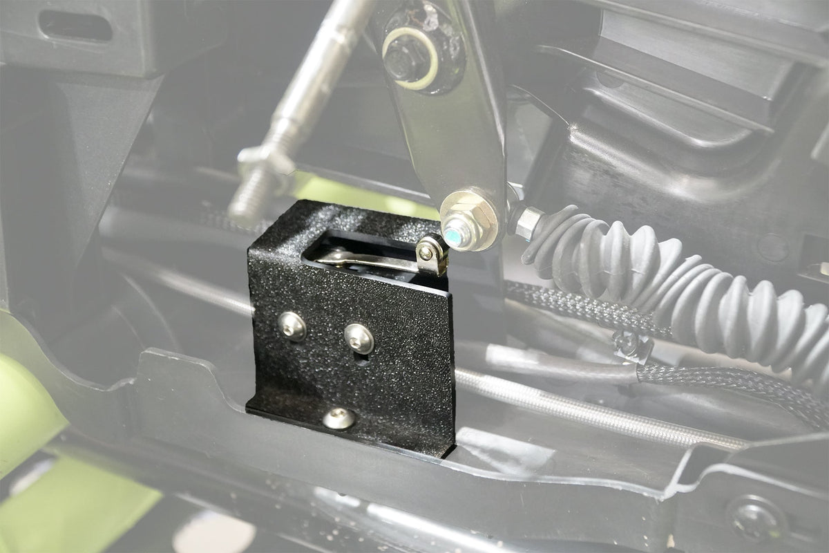 Black metal bracket installed on vehicle chassis with mechanical linkage