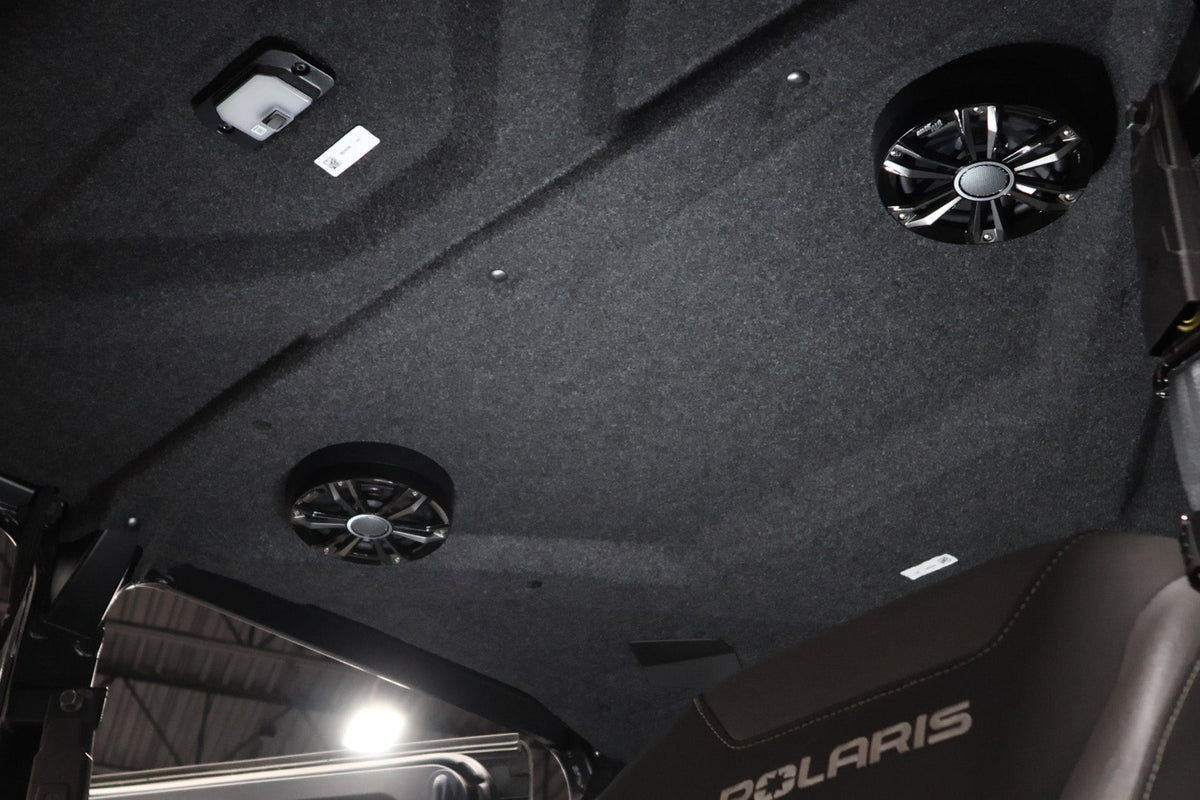 Polaris vehicle interior roof liner with integrated speakers and overhead light