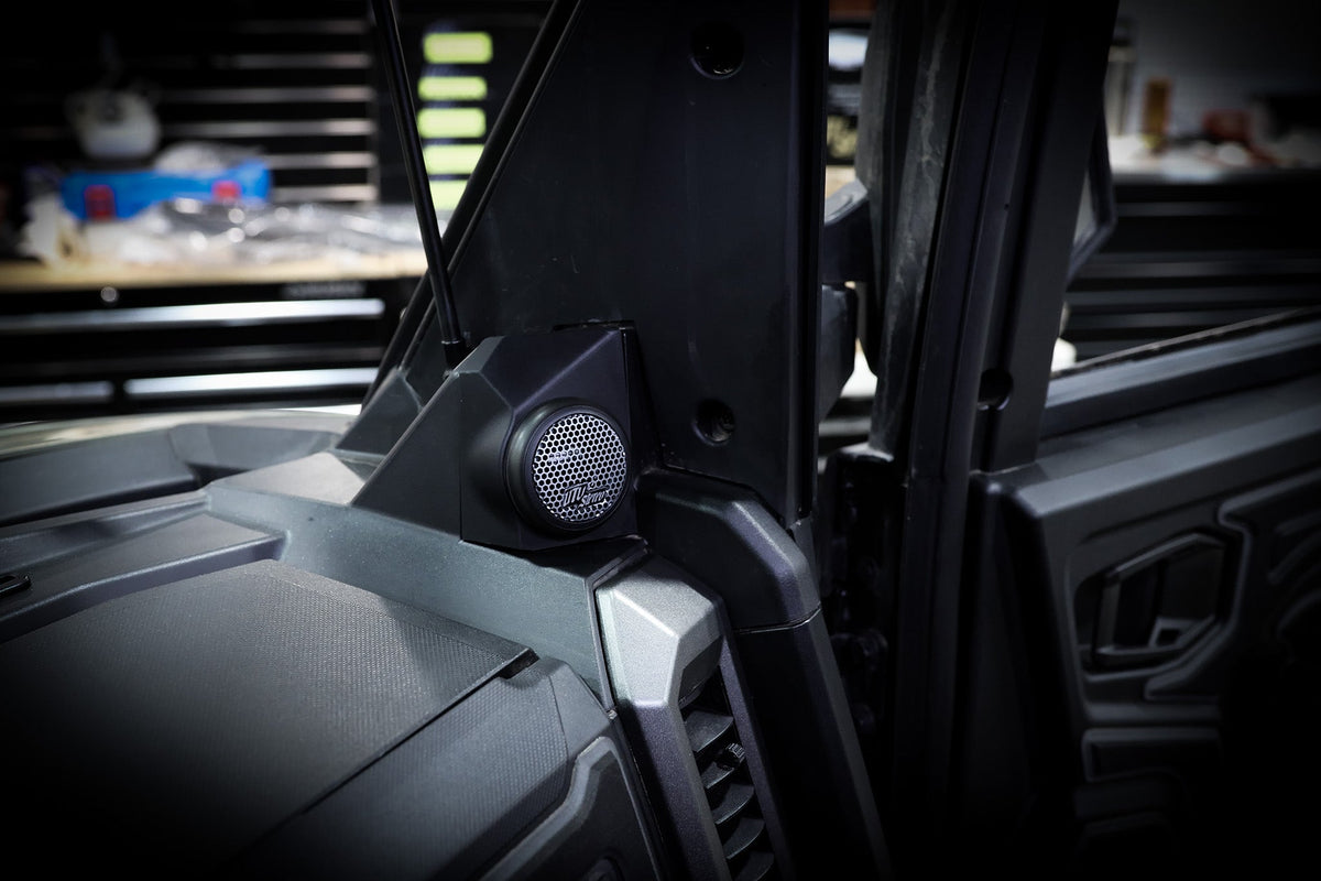UTV Stereo speaker mounted on the dashboard pillar of a vehicle