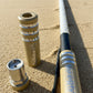 Beige and silver Marshin Whips branded lighted whip on the sandy beach