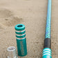 Teal game changer lighted whip on a sandy surface