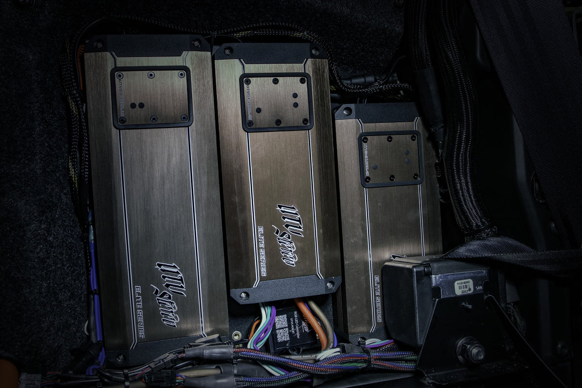Three UTV Stereo Elite Series amplifiers mounted in a vehicle with connected wiring