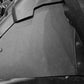 Black plastic interior side panel installed in a vehicle cabin