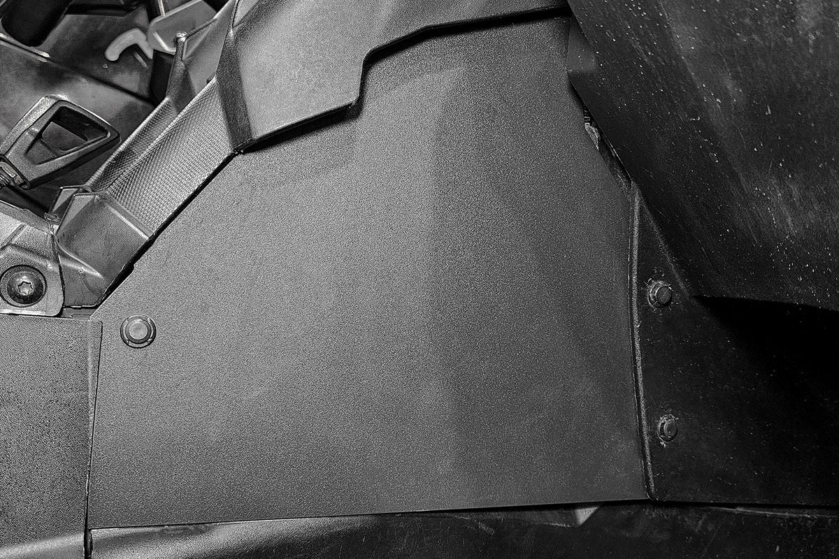 Black plastic interior side panel installed in a vehicle cabin