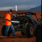 A person holding a work light next to a UTV as an alternative light source
