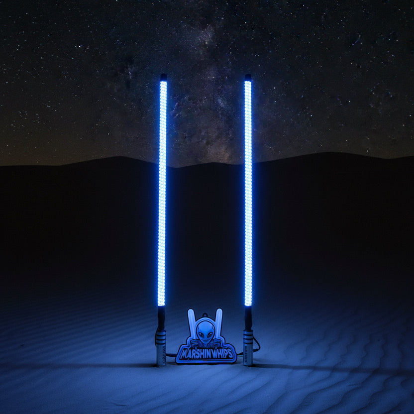 Two LED light whips on a dunes background glowing at night and 'Marshin Whips' branding.