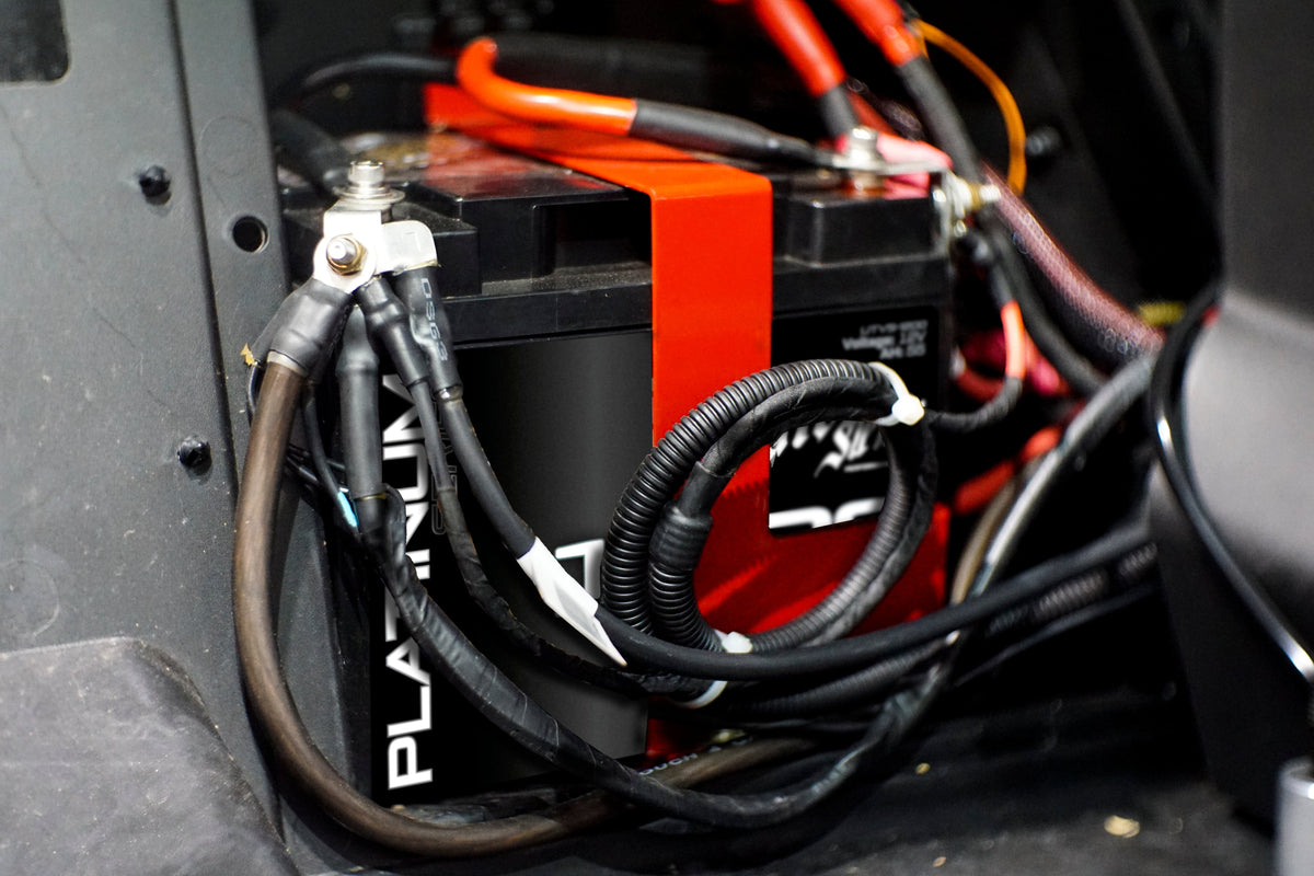UTV Stereo battery with red mounting bracket and connected wiring