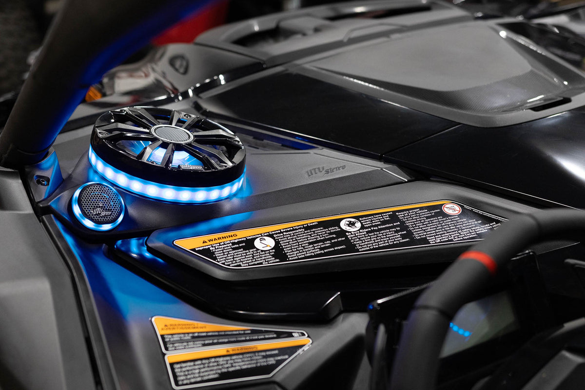 UTV Stereo speaker system with blue LED ring lighting installed in a vehicle dashboard