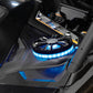 Round black speaker with blue LED ring light mounted on vehicle dashboard