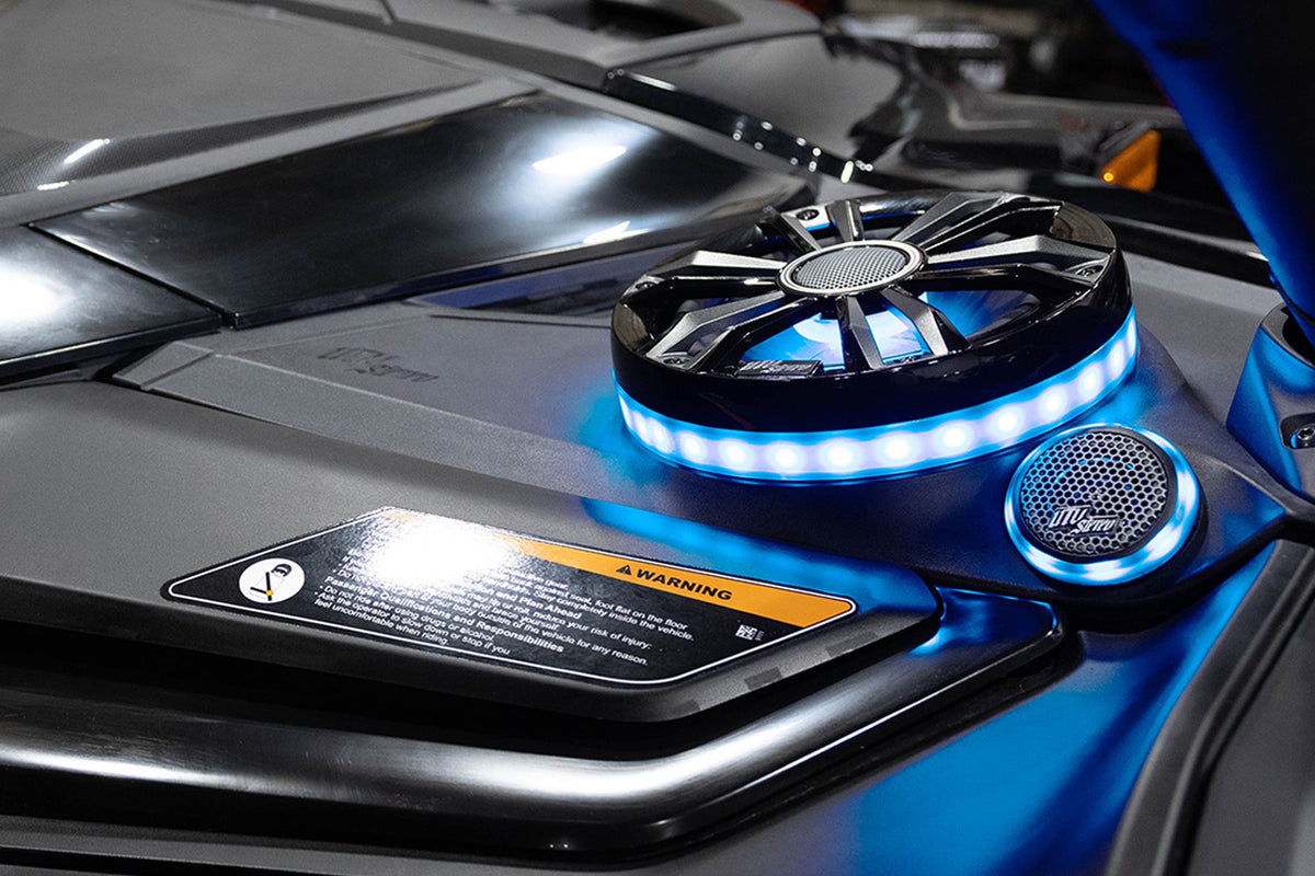 UTV Stereo speaker system with blue LED lighting installed on a vehicle dashboard