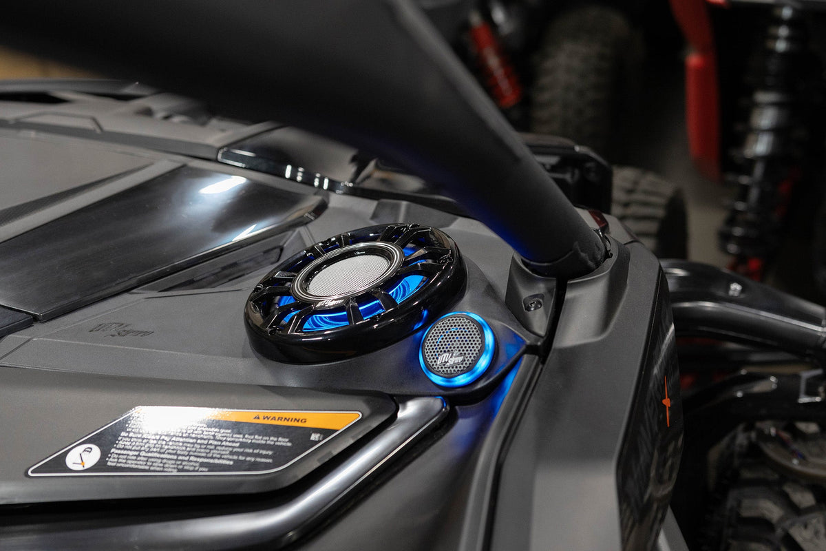 UTV Stereo speaker system with blue LED lighting installed on a vehicle dashboard