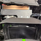 Digital display screen mounted on a vehicle dashboard with a protective hood