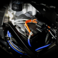 Vehicle battery with orange and blue wiring connections installed in engine bay