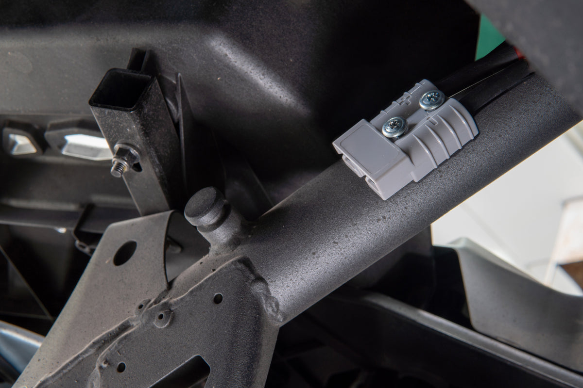 Grey electrical connector mounted on a black metal frame
