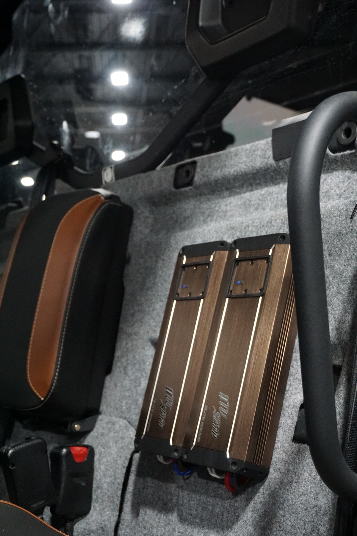 Two UTV Stereo Elite Series amplifiers mounted on the interior wall of a vehicle