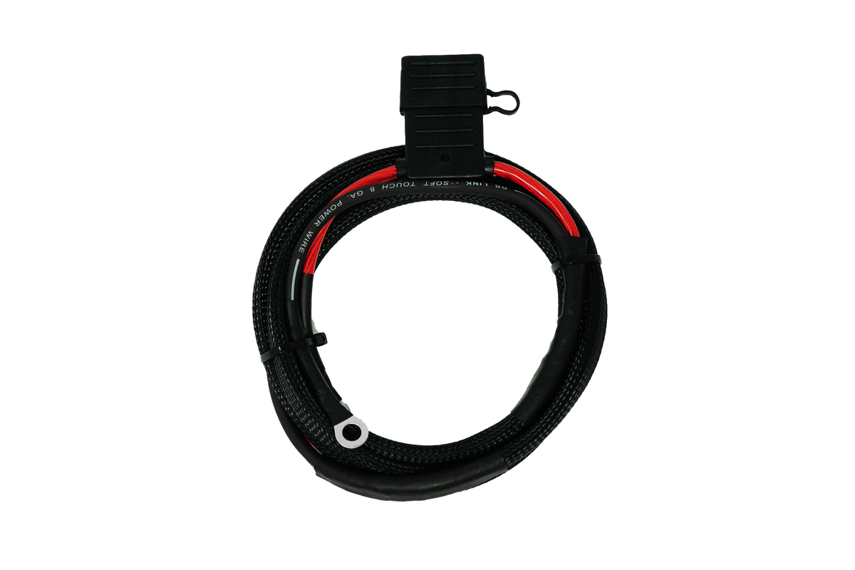 Coiled 8 gauge power wire with black protective sleeve and fuse holder