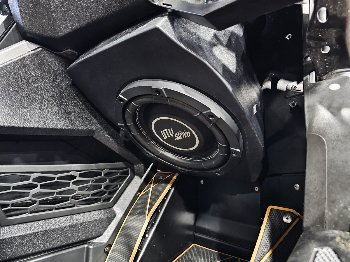 UTV Stereo subwoofer mounted in a vehicle interior panel