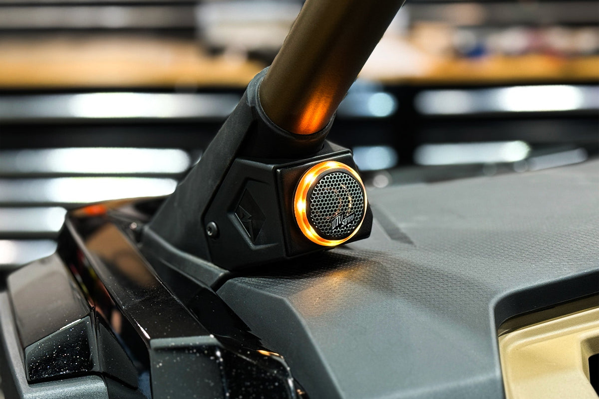 UTV Stereo speaker pod with amber LED ring light mounted on roll cage