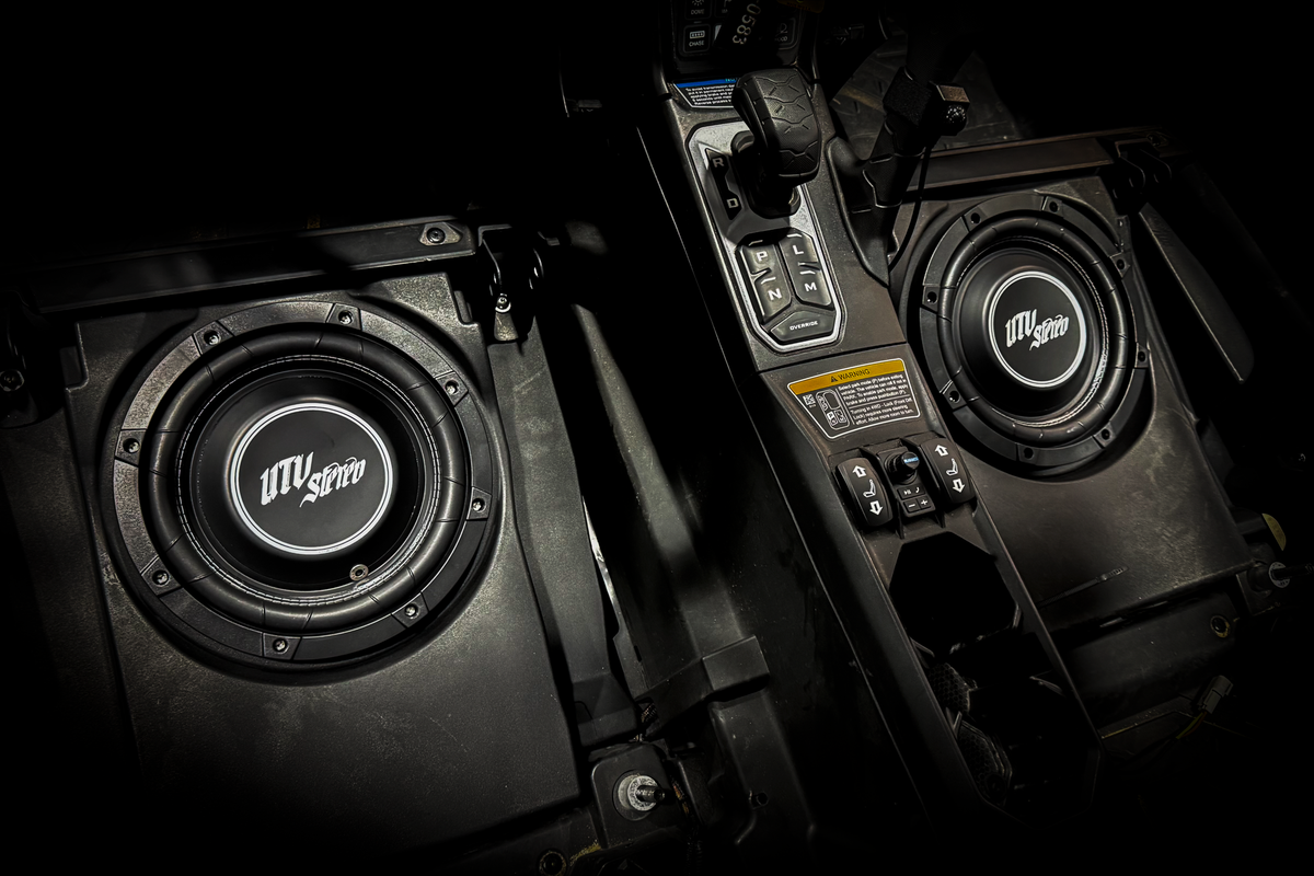 UTV Stereo subwoofer speakers installed in a vehicle center console