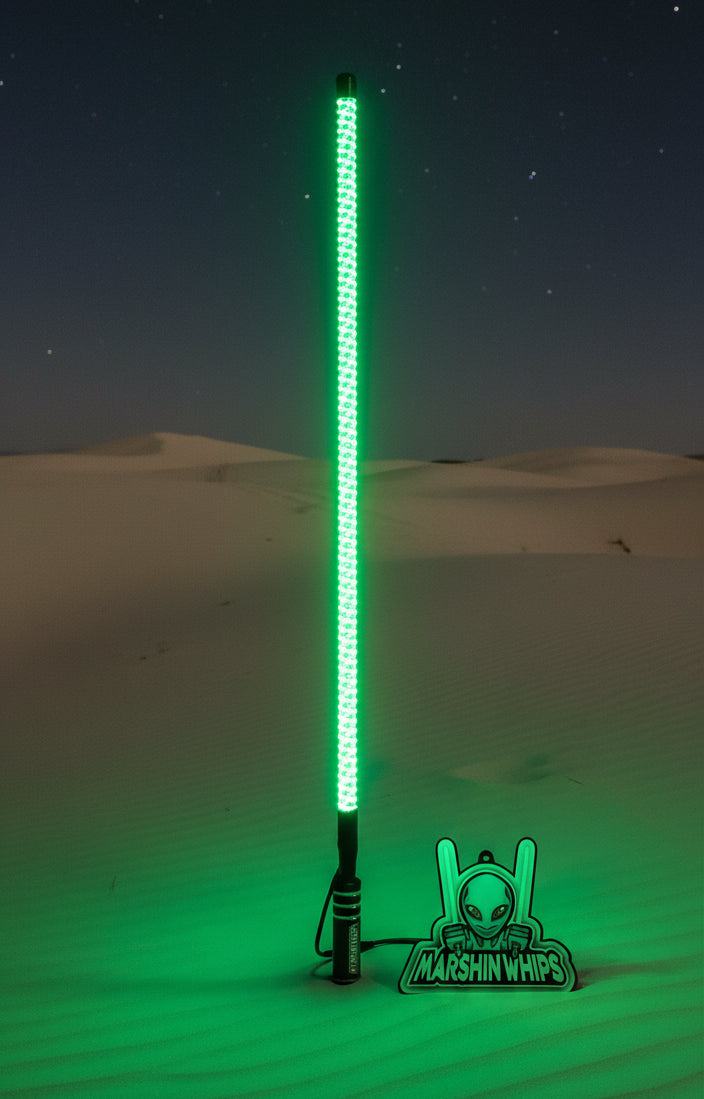 Light-up LED whip with glowing green LED strip against a green background, featuring the brand 'Marshin Whips'.